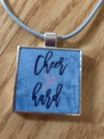 Cheer so hard designed silver squared necklace pendant with a blue cord chain