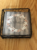 Four tile coaster set with a beautiful black coaster holder and  a 38401 zip code wood grain cotton ring monogram like wood look background.