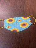 Sunflower Designed Blue Background with a yellow back and yellow ear loops Face Cover